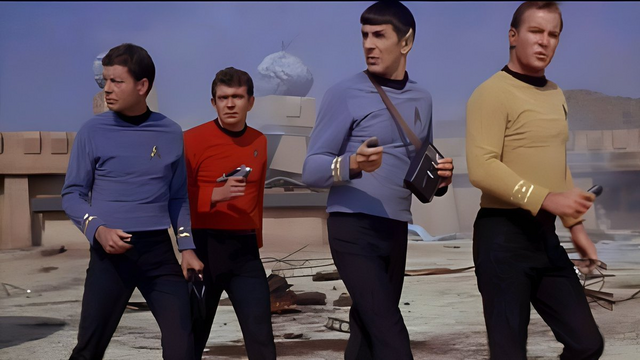 Bones, Spock, Kirk and some guy in a red jersey in a scene from Star Trek ...